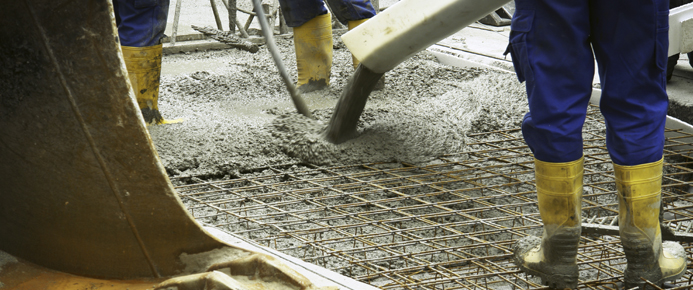 Workers placing concrete on a construction site