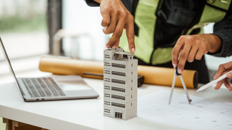Individuals collaborate on architectural engineering for condos and apartments, focusing on sustainable renovation and green energy solutions.