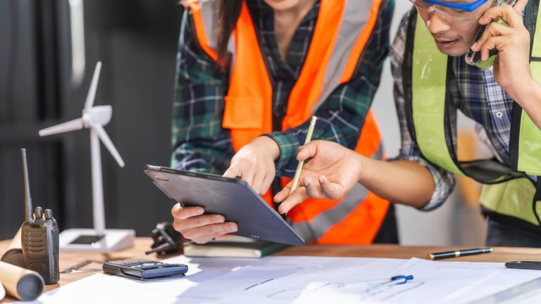 Young forewoman and middle-aged foreman advocate sustainability and clean energy solutions. Proficient in budgeting, design, and architectural planning for eco-friendly projects.