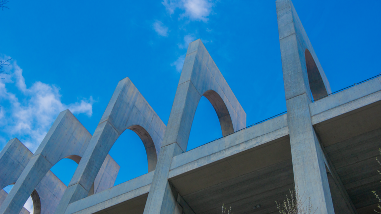 Low shot of a reinforced concrete bridge with a blue sky behind it