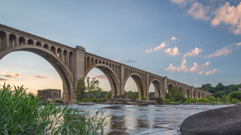 Low shot of a concrete bridge over a shallow waterway