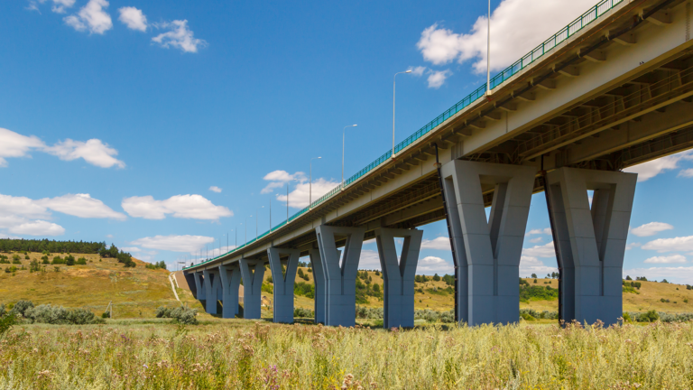 Concrete bridge surrounded by a grassy field