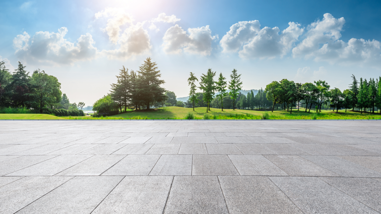 Concrete plaza with big city and trees in the distant background