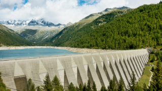 Concrete dam holding back reservoir of water