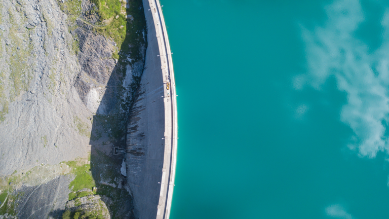 Aerial view of a concrete dam holding back water